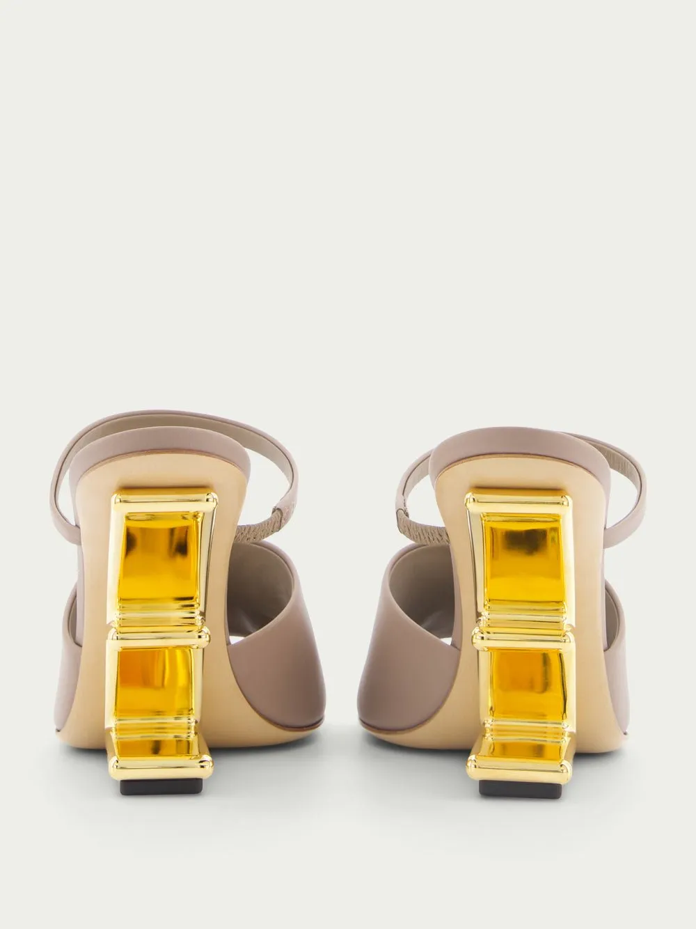 First high-heeled leather sandals