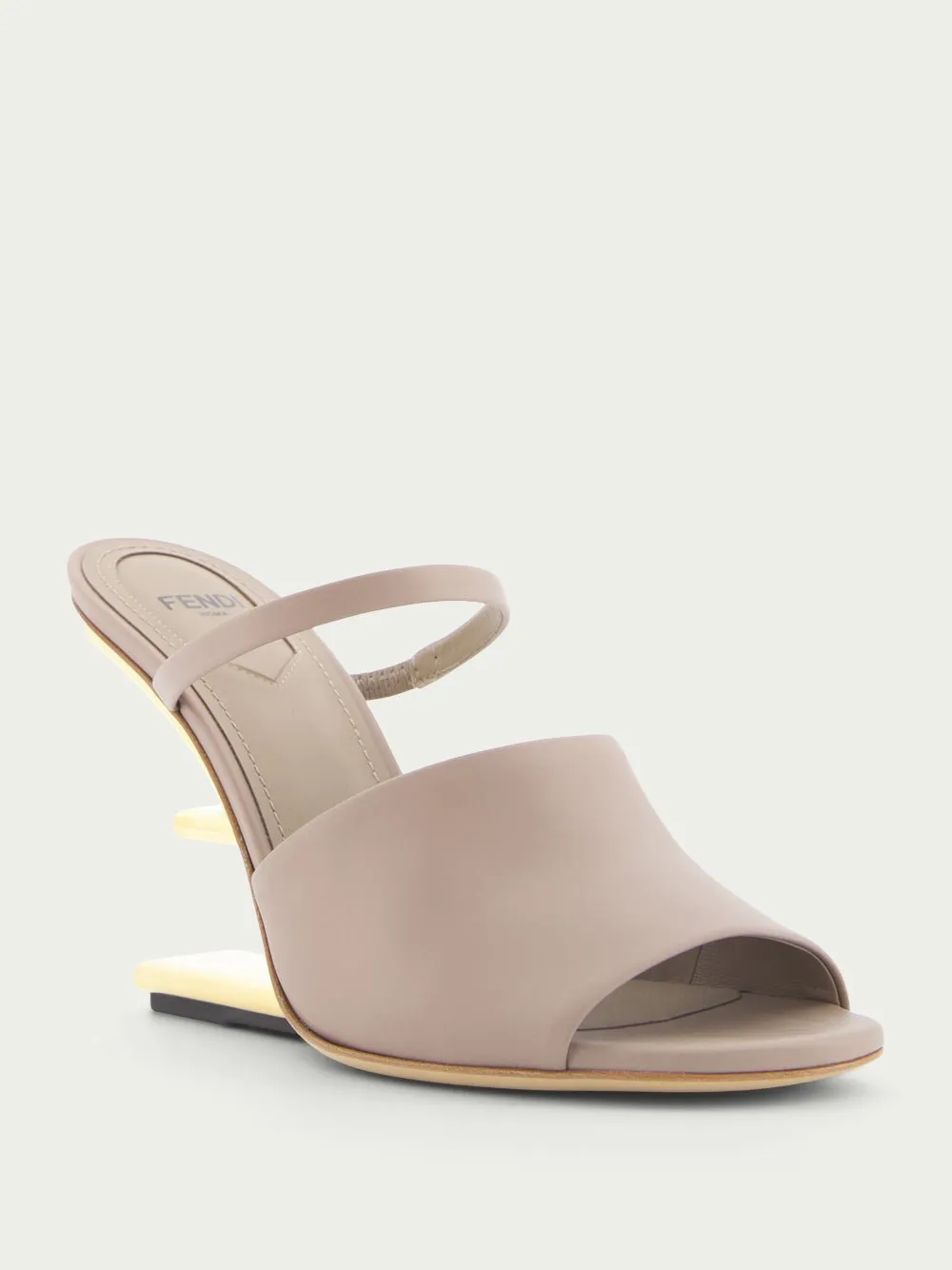 First high-heeled leather sandals