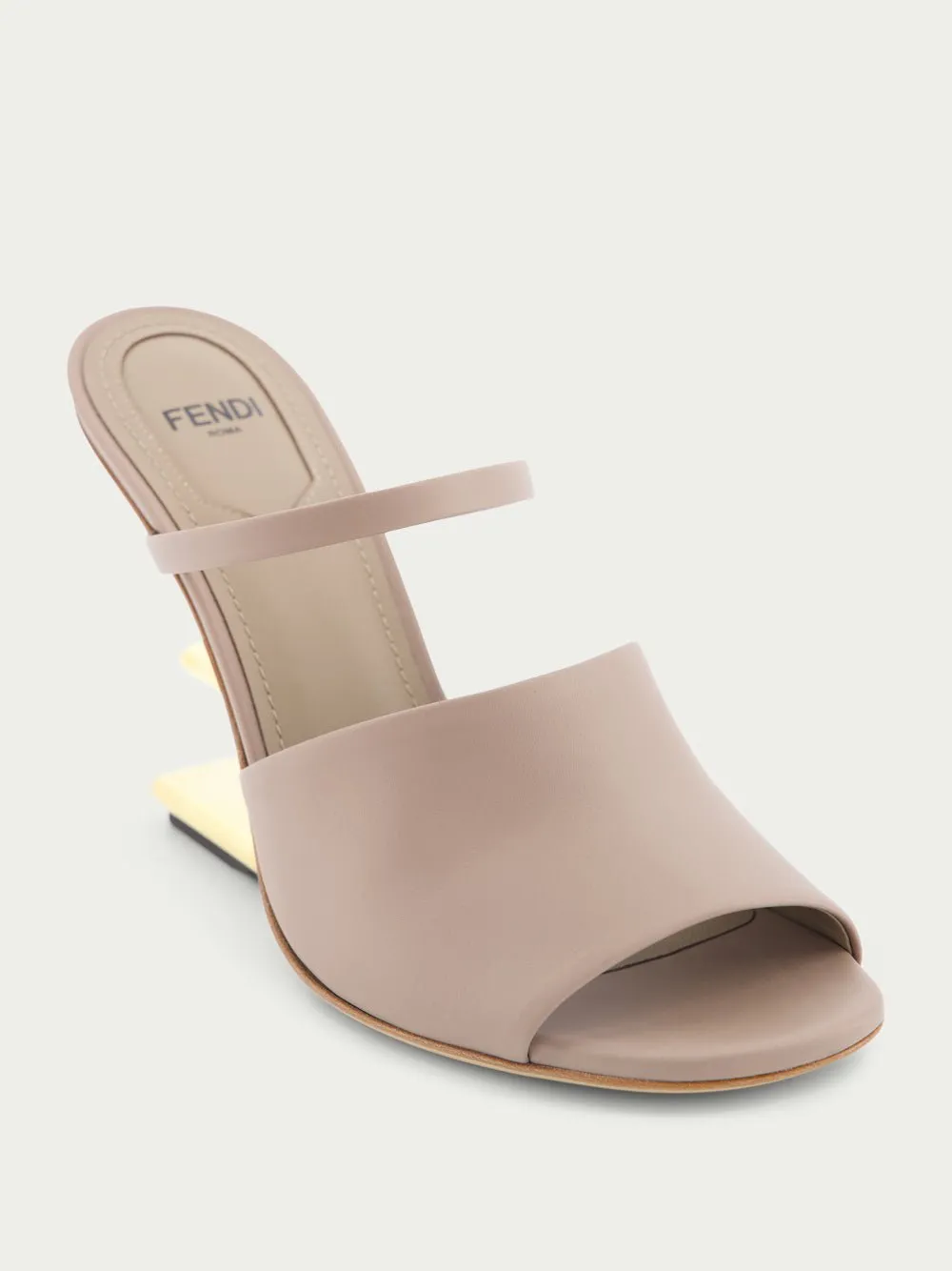 First high-heeled leather sandals