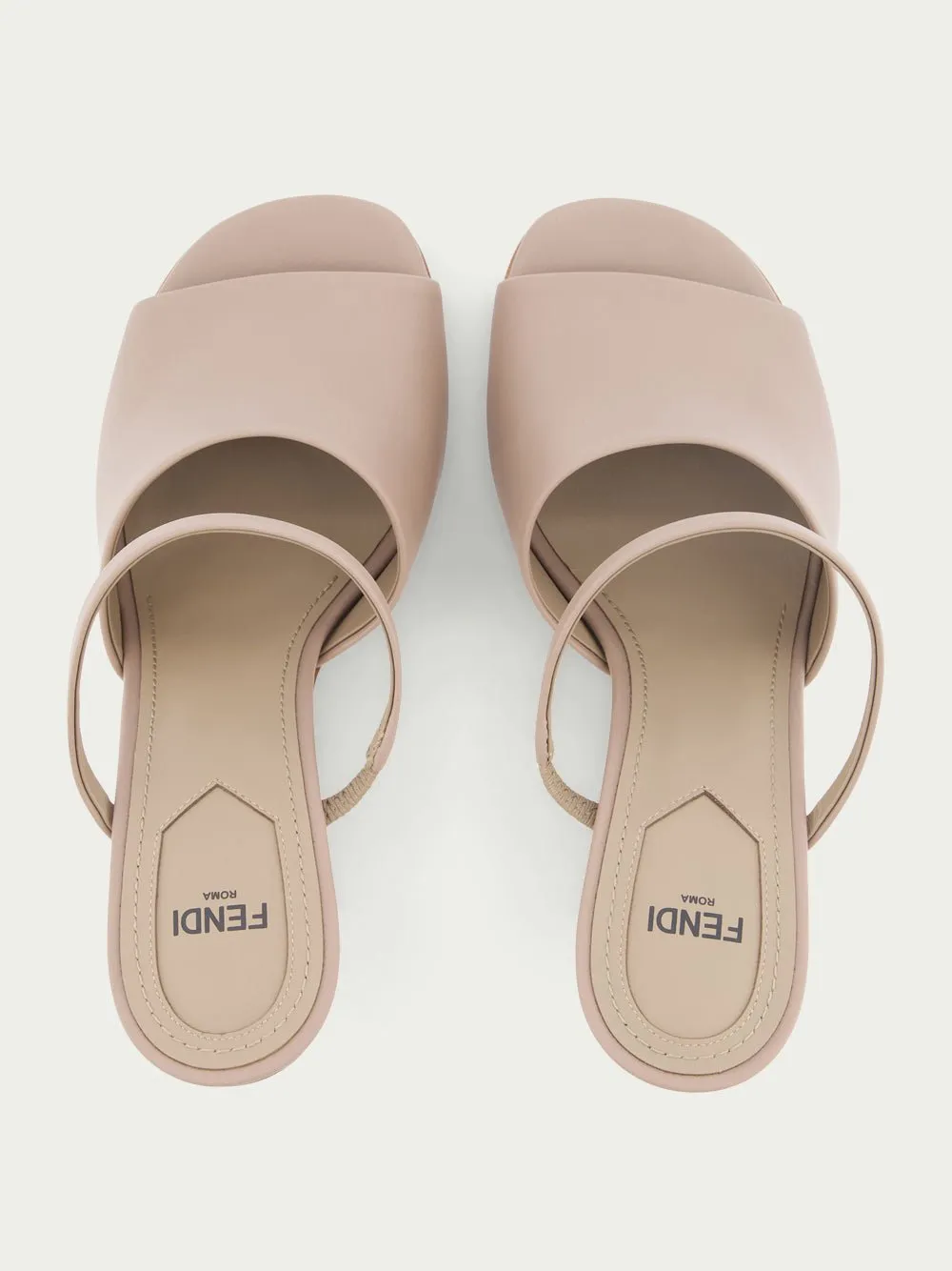 First high-heeled leather sandals