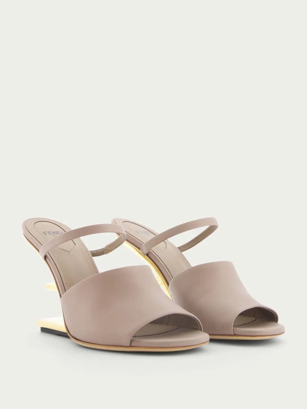 First high-heeled leather sandals